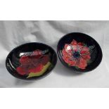 A Moorcroft pottery pedestal bowl decorated in the hibiscus pattern to a blue ground, 14cm diameter,
