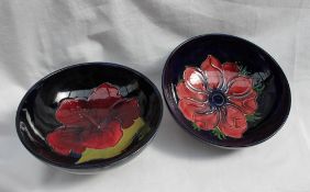 A Moorcroft pottery pedestal bowl decorated in the hibiscus pattern to a blue ground, 14cm diameter,