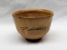 A Ray Finch studio pottery pedestal bowl, with a mustard yellow glaze an line decoration,