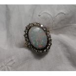 An opal and diamond ring the central oval opal approximately 17mm x 12mm,