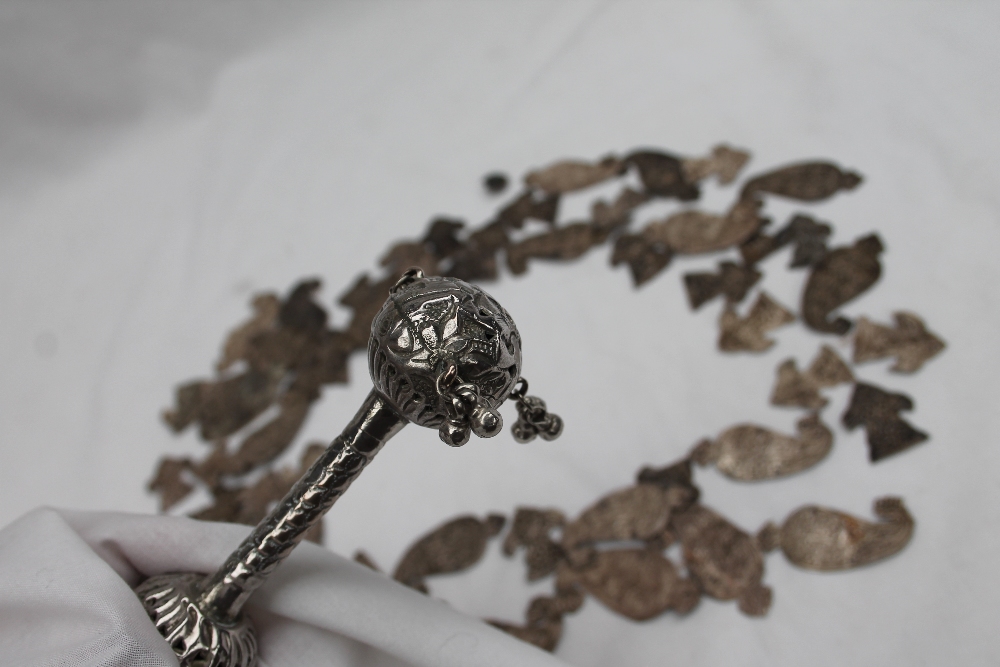 A white metal baby's rattle, with pierced ball ends and bells, - Image 3 of 3