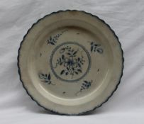 A 19th century blue and white dish of circular form with a feather edge,