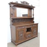 A late 19th century Low Countries carved oak mirrorback sideboard,