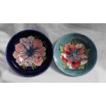 A Moorcroft pottery bowl decorated in the hibiscus pattern to a light blue ground, impressed mark,