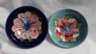 A Moorcroft pottery bowl decorated in the hibiscus pattern to a light blue ground, impressed mark,