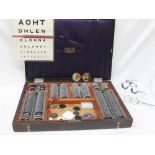 A Theodore Hamblin optometry set, with various lenses, contained in a case,