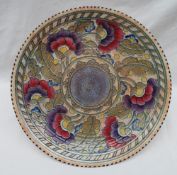 A Crown Ducal, Charlotte Rhead pottery charger decorated with purple,