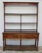 An 18th century South Wales oak dresser, the moulded cornice above three shelves,