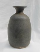 A studio pottery vase, with a mottled blue green ground, impressed with initials and "TUGWMMWD",