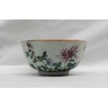 A Chinese polychrome decorated porcelain bowl, decorated with flowerheads and leaves,