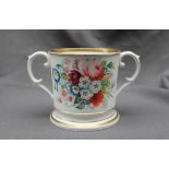 A 19th century English porcelain twin handled loving cup, painted with sprays of garden flowers, 12.