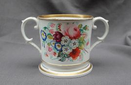 A 19th century English porcelain twin handled loving cup, painted with sprays of garden flowers, 12.