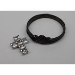A silver paste set cross pendant together with a heavy white metal interlaced slave bracelet