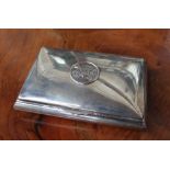 A Peruvian white metal hinged box and cover, of rectangular form, with an embossed roundel,