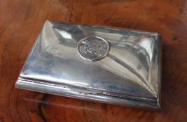 A Peruvian white metal hinged box and cover, of rectangular form, with an embossed roundel,