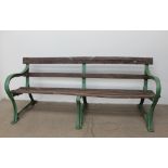 A Cast iron and slatted park bench, with three leg supports and wooden slats, cast "GW",