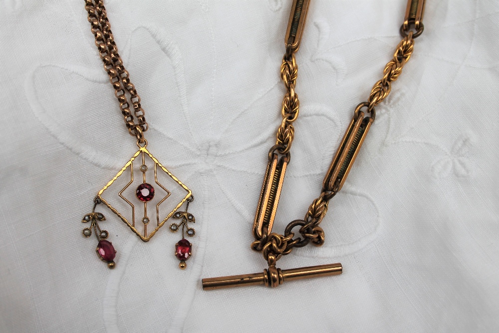 A 9ct yellow gold chain together with a yellow metal pendant set with garnets and pearls