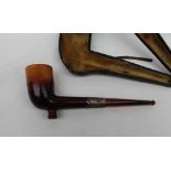 A Meerschaum pipe, with a silver collar and amber mouth piece,