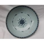 An 18th century blue and white Delft bowl, painted to the exterior with flowers,