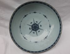 An 18th century blue and white Delft bowl, painted to the exterior with flowers,