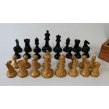 A Staunton type ebonised and boxwood chess set, knights and rooks with impressed crown marks,