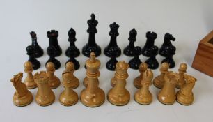 A Staunton type ebonised and boxwood chess set, knights and rooks with impressed crown marks,