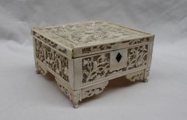 A late 19th century pierced ivory box and cover of rectangular form decorated with birds flowers