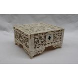 A late 19th century pierced ivory box and cover of rectangular form decorated with birds flowers
