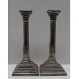 A pair of Elizabeth II silver candlesticks, of corinthian column form, with a removable sconce,