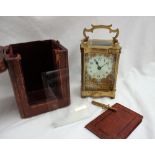 A 19th century French brass carriage clock, with a serpentine case and handle,