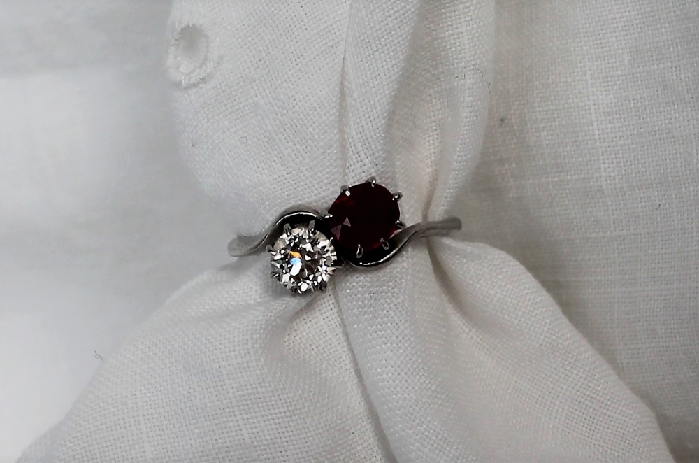 A ruby and diamond crossover ring, the round old cut diamond approximately 0.