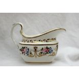 A Swansea porcelain cream jug, painted with roses and gilt swags and a scrolling handle,