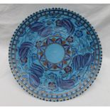 A Crown Ducal, Charlotte Rhead pottery charger decorated with purple,