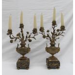 A pair of ormolu candelabra in the form of vases of flowers with three rose heads and leaves on urn