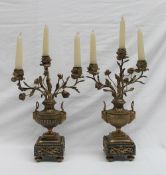 A pair of ormolu candelabra in the form of vases of flowers with three rose heads and leaves on urn