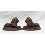 A pair of 19th century saltglazed recumbent lions, on a stepped oval base, 11cm high x 16.
