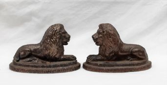 A pair of 19th century saltglazed recumbent lions, on a stepped oval base, 11cm high x 16.