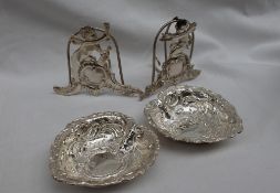 A pair of Elizabeth II silver heart shaped dishes, embossed with scrolls and leaves, Sheffield,