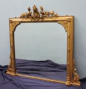 A 19th century gilt gesso overmantle mirror with a floral and leaf cresting,