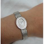 A Lady's 9ct white gold wristwatch, the oval dial with batons inscribed Bueche Girod,
