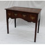 An 18th century oak lowboy, the rectangular planked top above three drawers,
