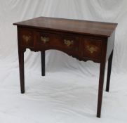 An 18th century oak lowboy, the rectangular planked top above three drawers,