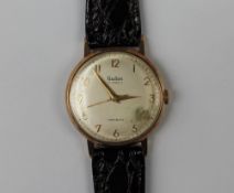 A 9ct yellow gold Gentleman's wristwatch, the silvered dial with Arabic numerals, inscribed Audax,