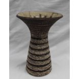 Waistel Cooper - a studio pottery vase with a flared rim and tapering cylindrical textured body in