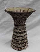 Waistel Cooper - a studio pottery vase with a flared rim and tapering cylindrical textured body in