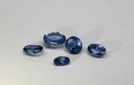 Five assorted loose sapphires, all light in colour, various cuts,
