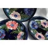 Three Moorcroft pottery plates, decorated in the anemone pattern in blues,