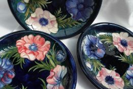 Three Moorcroft pottery plates, decorated in the anemone pattern in blues,