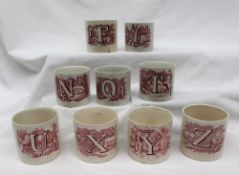 Children's china - Nine pottery mugs each printed with a letter of the alphabet and a