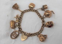 A 9ct yellow gold bracelet set with numerous charms including Capricorn, stein, anchor, heart,